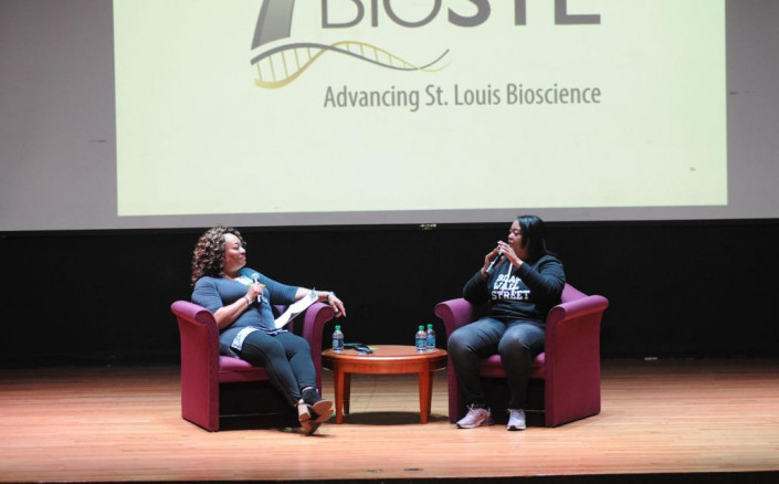 Photo of Cheryl Watkins-Moore and another women talking at a conference